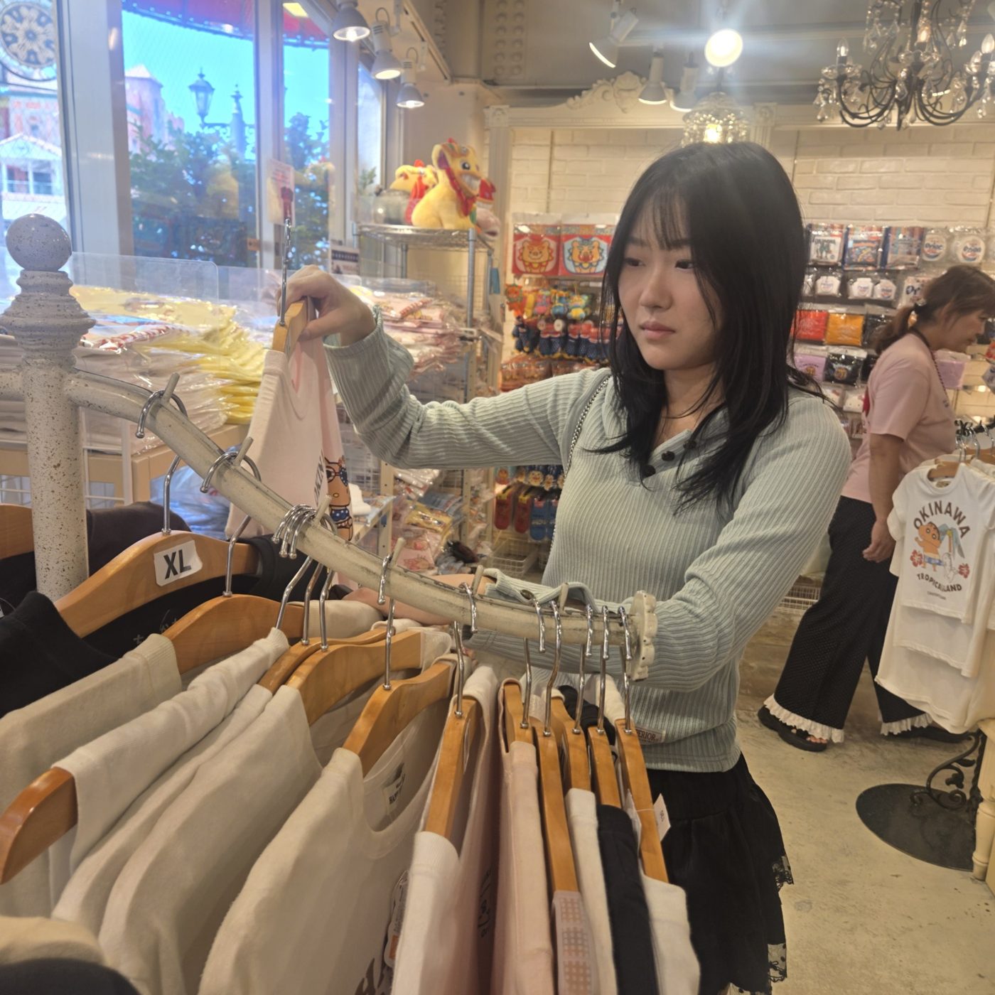 옷 가게에서 옷을 고르는 딸