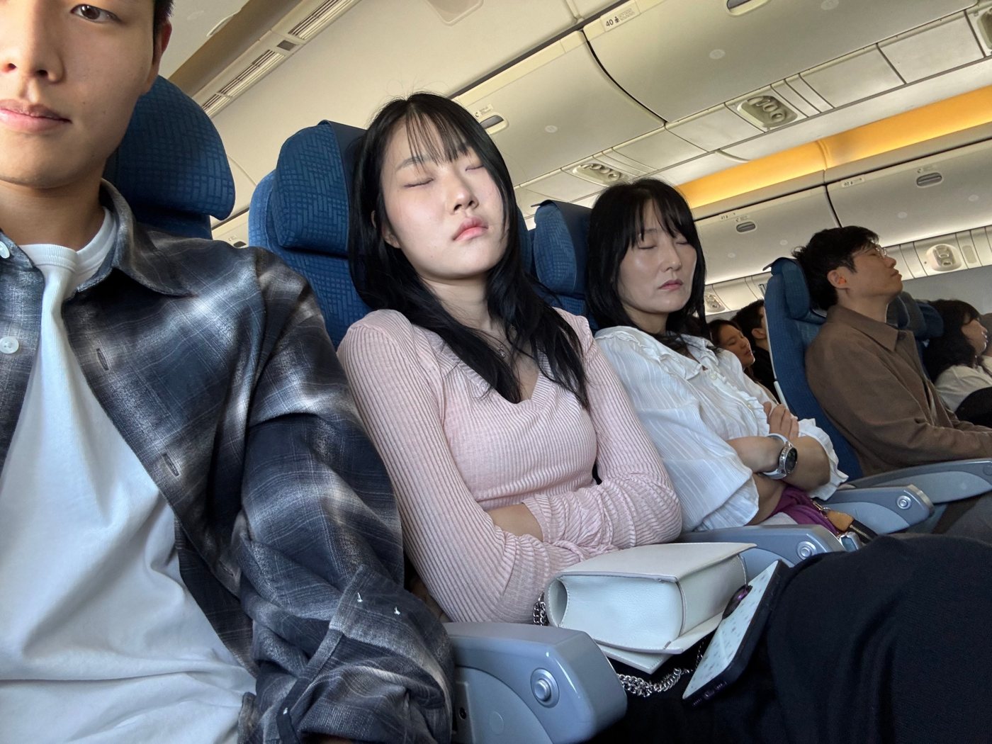 오키나와로 가는 비행기 안에서 잠든 딸과 엄마, 아빠 그리고 셀카를 찍는 아들